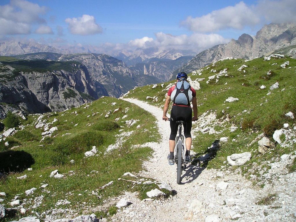 Mountain biker following a rocky trail through mountains