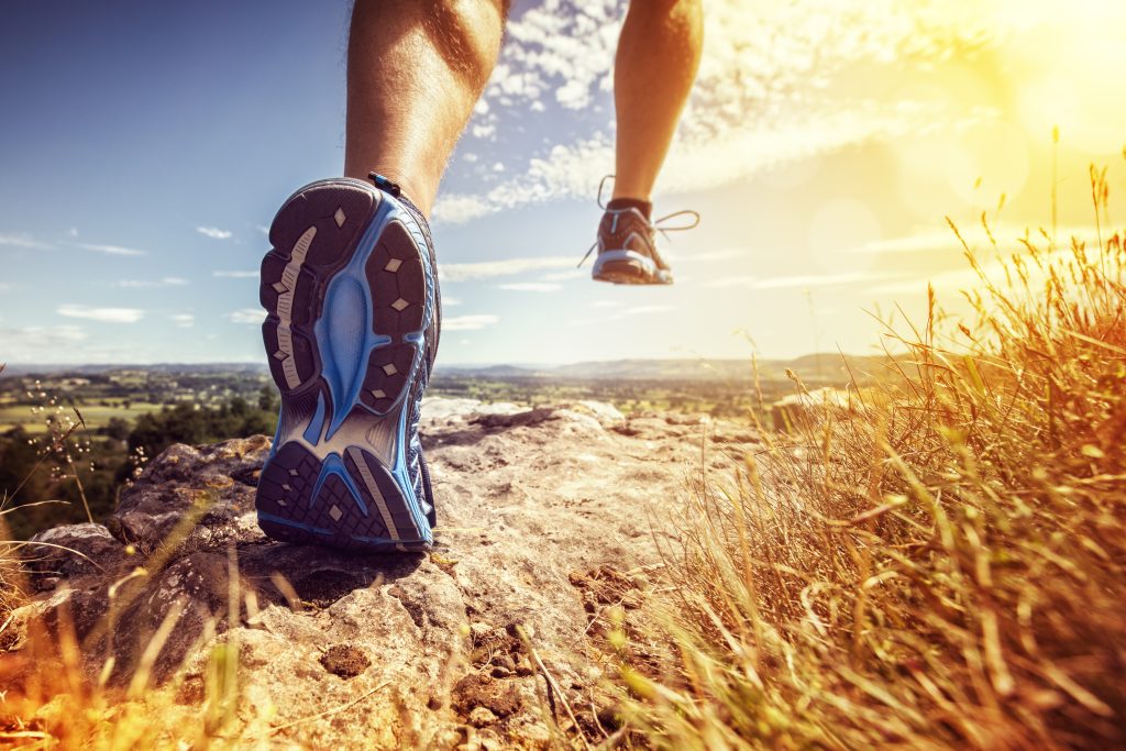 Running shoes on a rocky trail